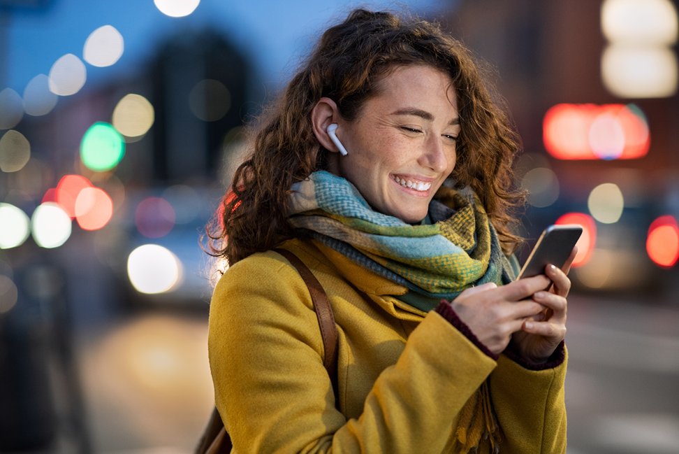 Woman smiling using her phone